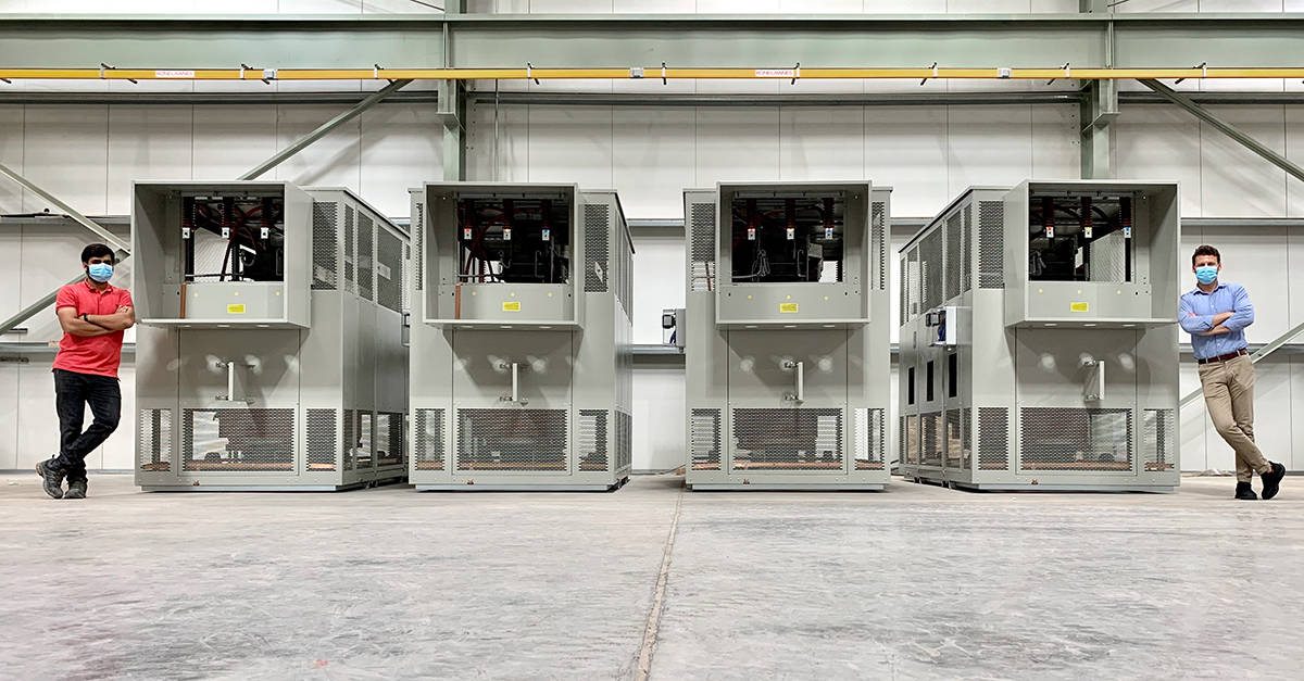 Cast resin transformers in factory with two employees